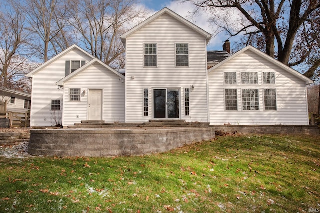 rear view of house with a lawn