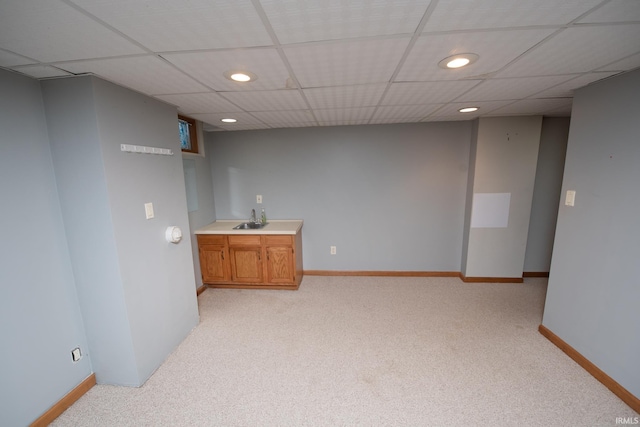 bar with a drop ceiling, sink, and light carpet