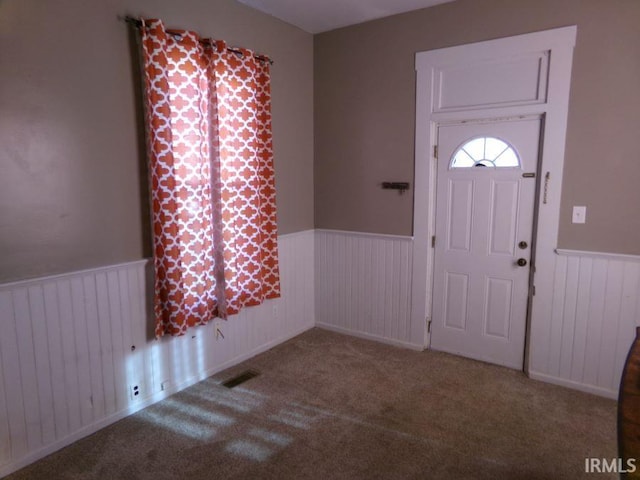 entryway featuring radiator and carpet