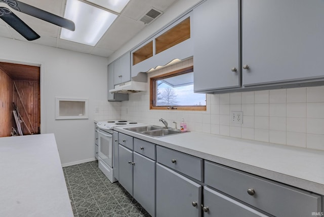 kitchen featuring white range with electric stovetop, tasteful backsplash, sink, and gray cabinetry