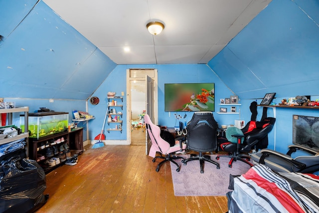 home office with hardwood / wood-style floors and vaulted ceiling