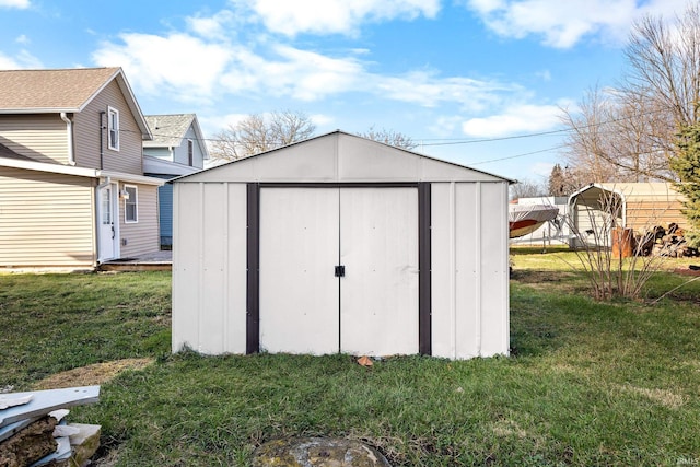 view of outdoor structure with a yard and a carport