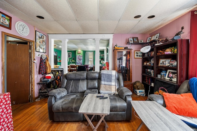 living room with ornate columns and hardwood / wood-style flooring