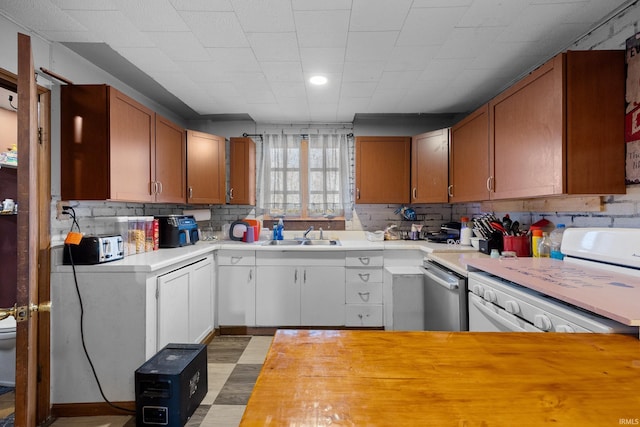 kitchen with white cabinets, white stove, tasteful backsplash, and stainless steel dishwasher