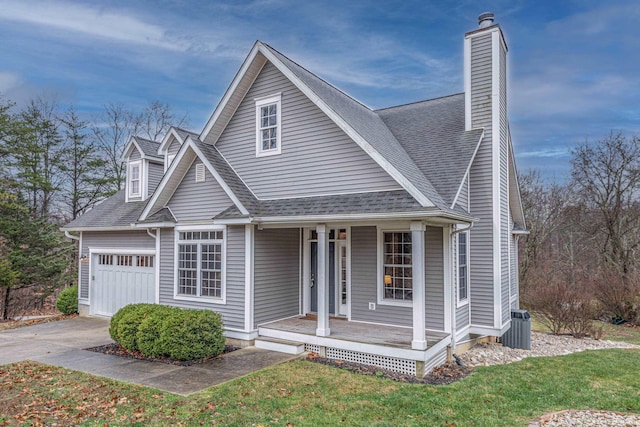 view of front of house with a front yard, a porch, and central AC