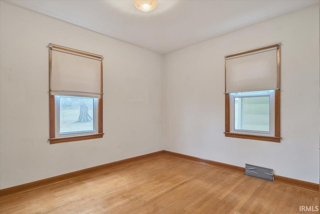 unfurnished room featuring hardwood / wood-style floors