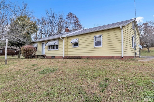 view of property exterior with a yard