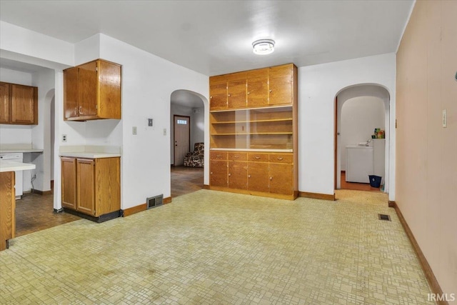 kitchen with white dishwasher and washer / dryer