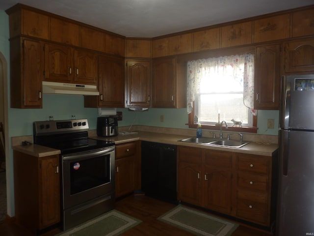 kitchen with dark hardwood / wood-style flooring, sink, and stainless steel appliances