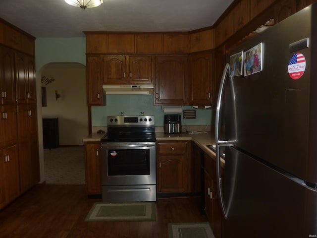 kitchen featuring dark hardwood / wood-style flooring and stainless steel appliances