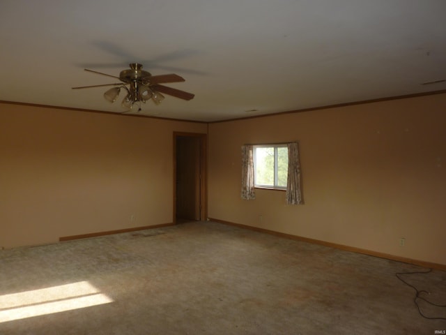 spare room featuring ceiling fan, carpet, and ornamental molding