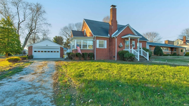 view of front of home with a garage, an outbuilding, and a front yard