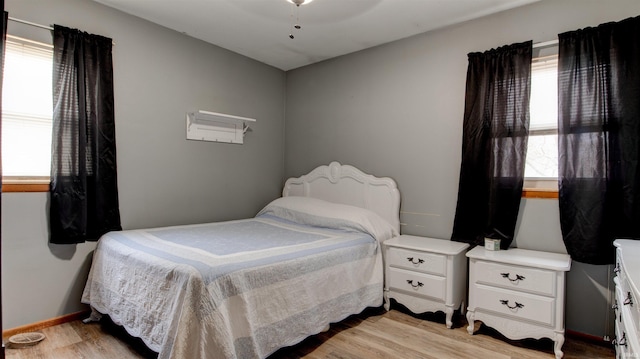 bedroom featuring ceiling fan and light hardwood / wood-style flooring