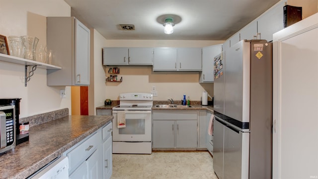 kitchen featuring dishwasher, stainless steel fridge, white range with electric cooktop, and sink