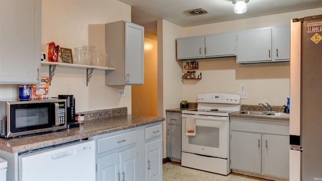 kitchen featuring sink and white appliances