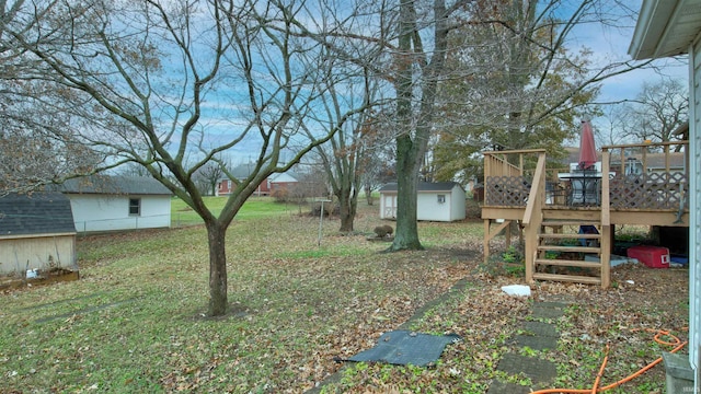 view of yard with a wooden deck and a shed