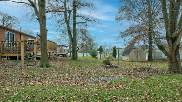 view of yard with a storage shed and a deck