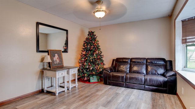 living room with light hardwood / wood-style flooring and ceiling fan