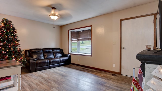 living room with hardwood / wood-style flooring and ceiling fan