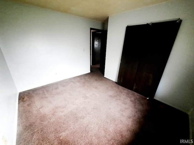 unfurnished bedroom featuring carpet flooring