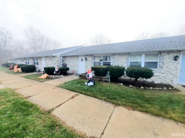 single story home with a front lawn