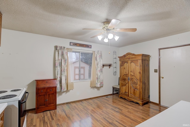 bedroom featuring ceiling fan, a textured ceiling, and light hardwood / wood-style flooring