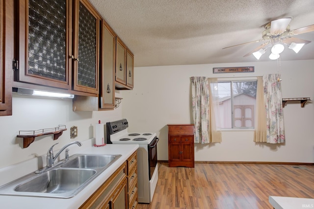 kitchen featuring a textured ceiling, ceiling fan, sink, light hardwood / wood-style flooring, and white range with electric cooktop