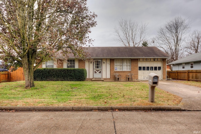 ranch-style home with a garage and a front yard