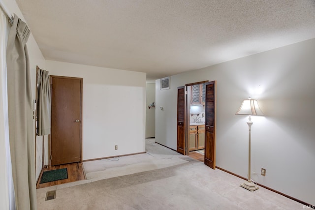 unfurnished bedroom with a textured ceiling