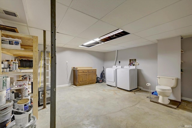 basement featuring a drop ceiling and independent washer and dryer