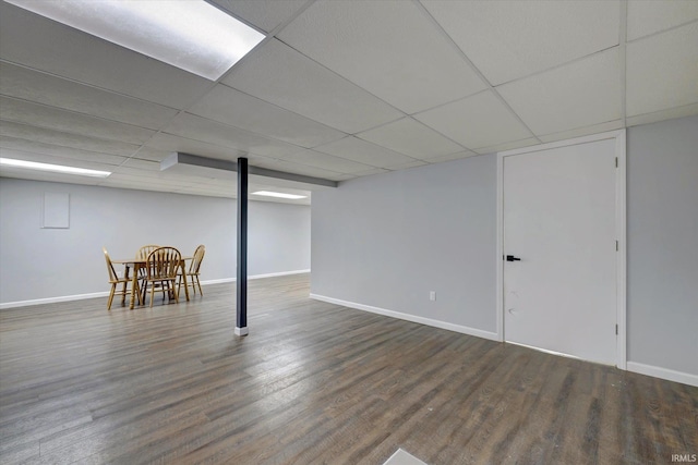 basement featuring dark hardwood / wood-style floors and a drop ceiling