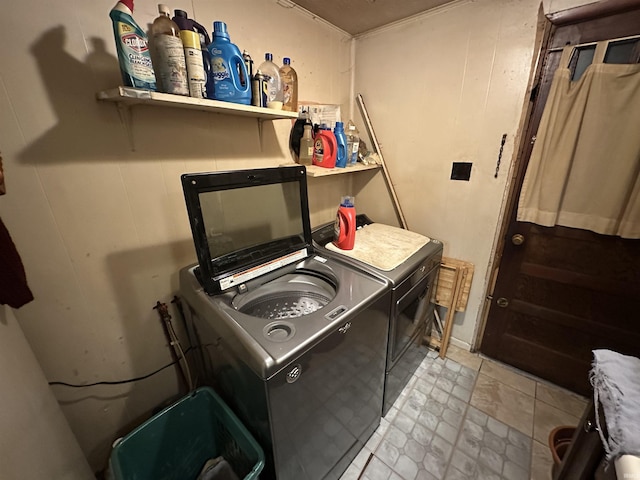 laundry room featuring light tile patterned floors and washer and dryer