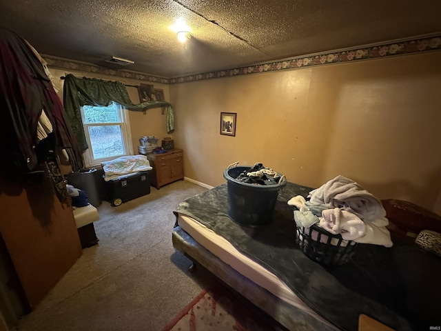 bedroom with carpet and a textured ceiling