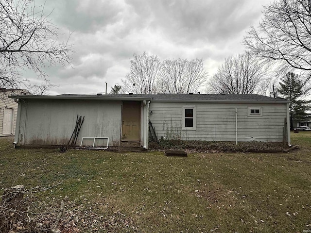 rear view of property featuring a yard