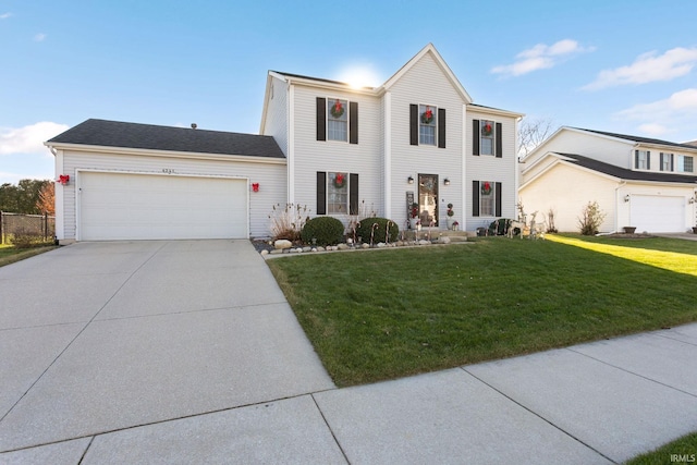 view of front of property featuring a front yard and a garage