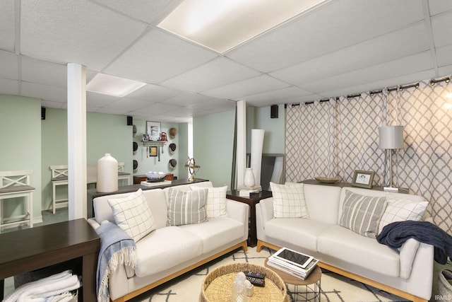 living room featuring a paneled ceiling