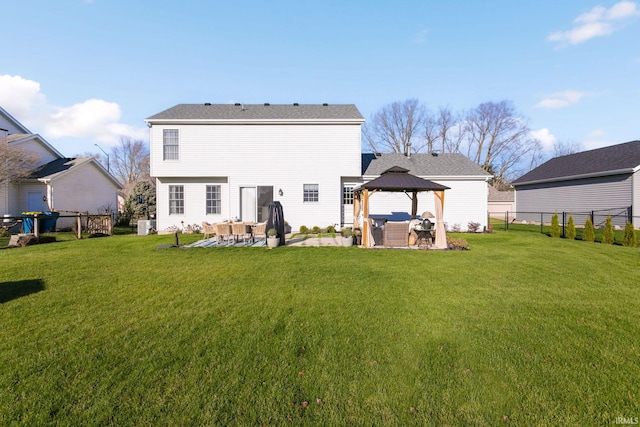 back of house with a gazebo, a yard, and a patio