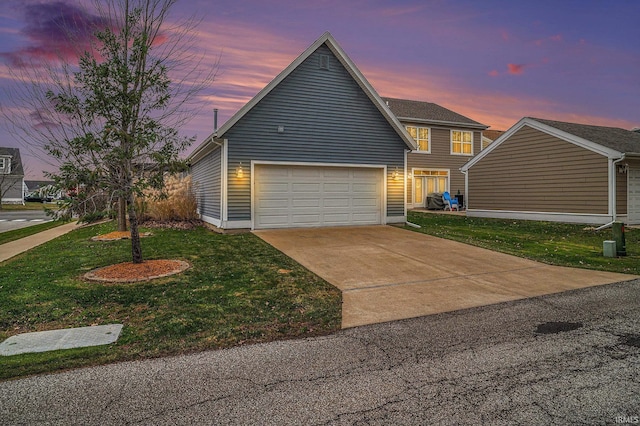 view of front of house featuring a garage and a yard