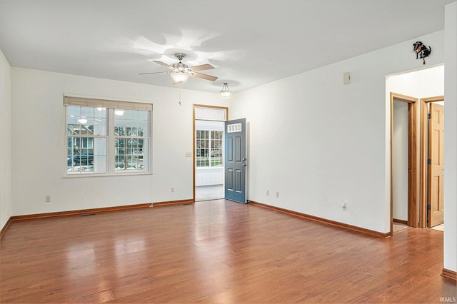 spare room with hardwood / wood-style flooring and ceiling fan