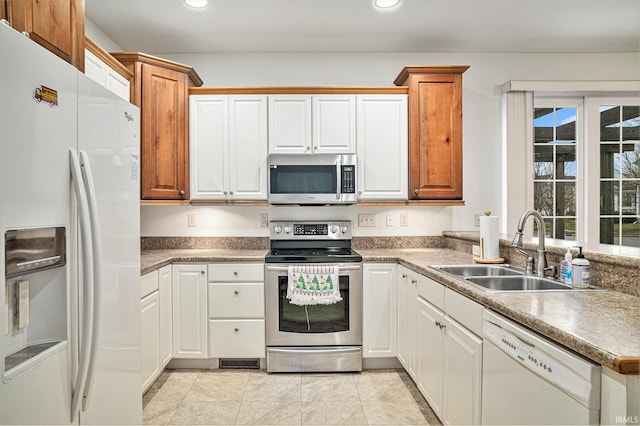 kitchen with white cabinets, sink, and stainless steel appliances