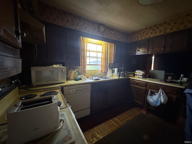 kitchen with white appliances, ventilation hood, sink, a textured ceiling, and dark brown cabinetry