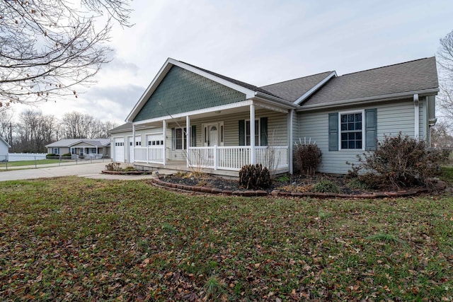 view of front of home with a front lawn, a porch, and a garage