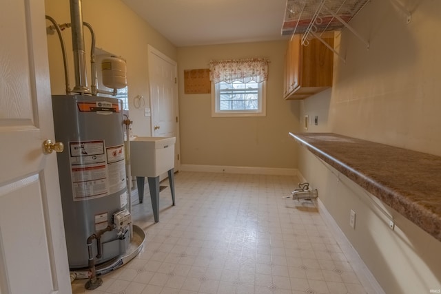 laundry area featuring cabinets, hookup for an electric dryer, and gas water heater