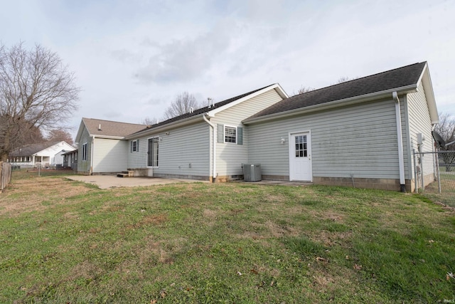 back of property featuring central AC unit, a patio area, and a yard