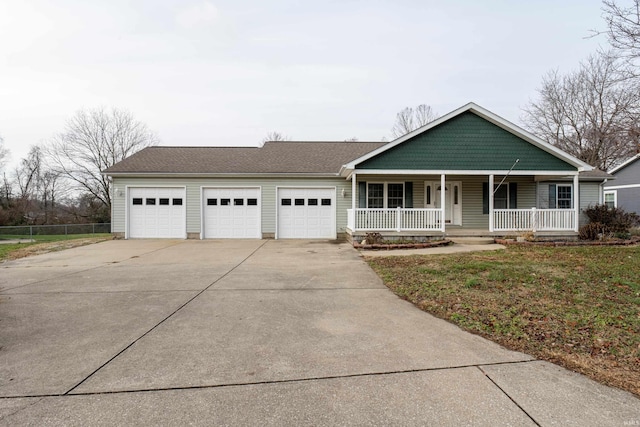 view of front of property with a front yard, a porch, and a garage