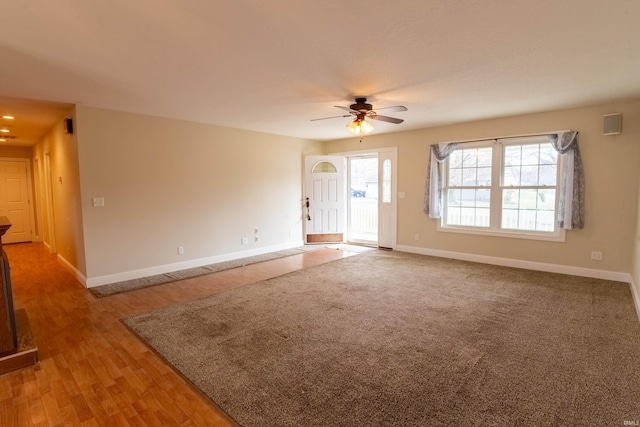 unfurnished living room with wood-type flooring and ceiling fan