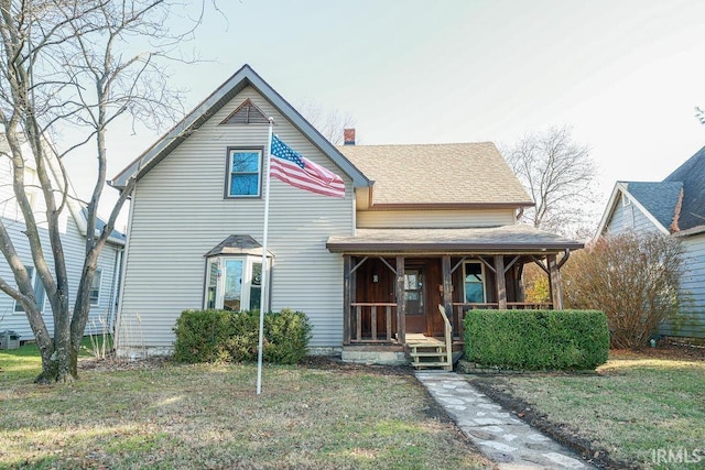 view of front of house with covered porch and a front yard