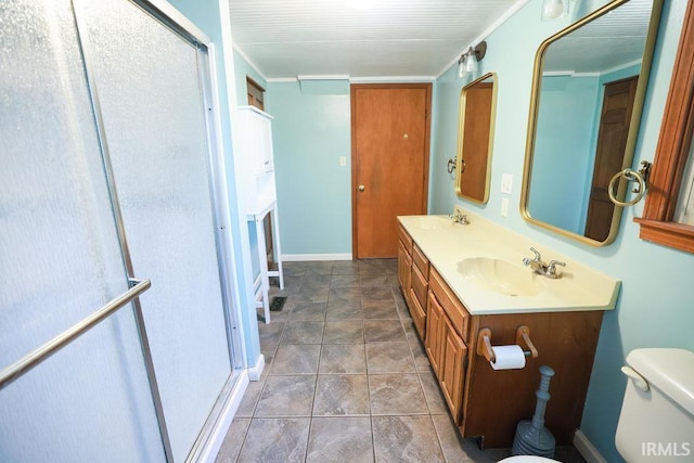 bathroom featuring tile patterned flooring, vanity, toilet, and a shower with door