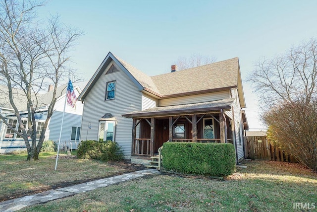 view of front of property featuring a front yard and a porch