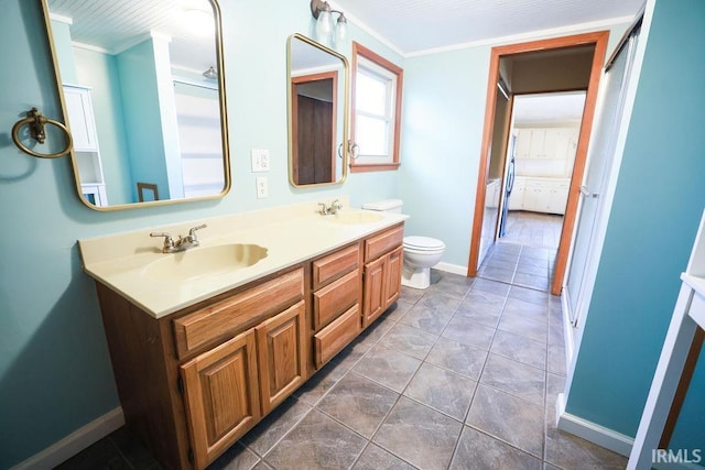 bathroom featuring tile patterned flooring, vanity, toilet, and ornamental molding